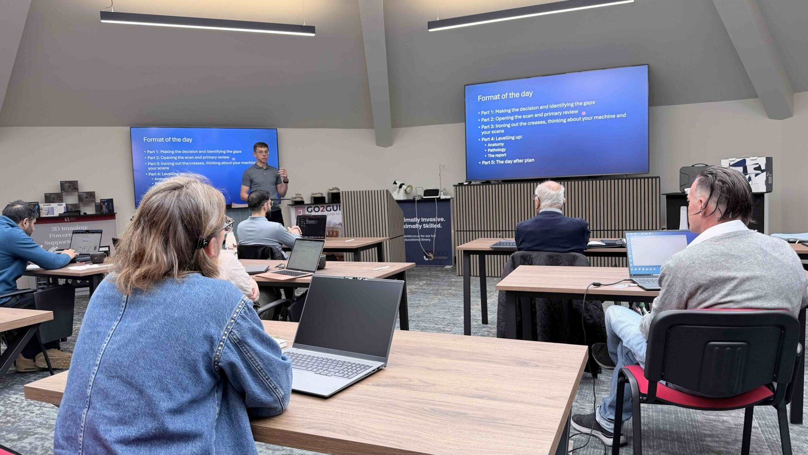 Delegates with laptops at a CBCT course in the Octagon House training room