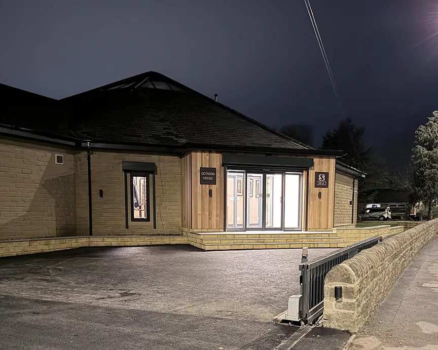 Octagon House, the 360 Visualise office in West Yorkshire, lit up at dusk