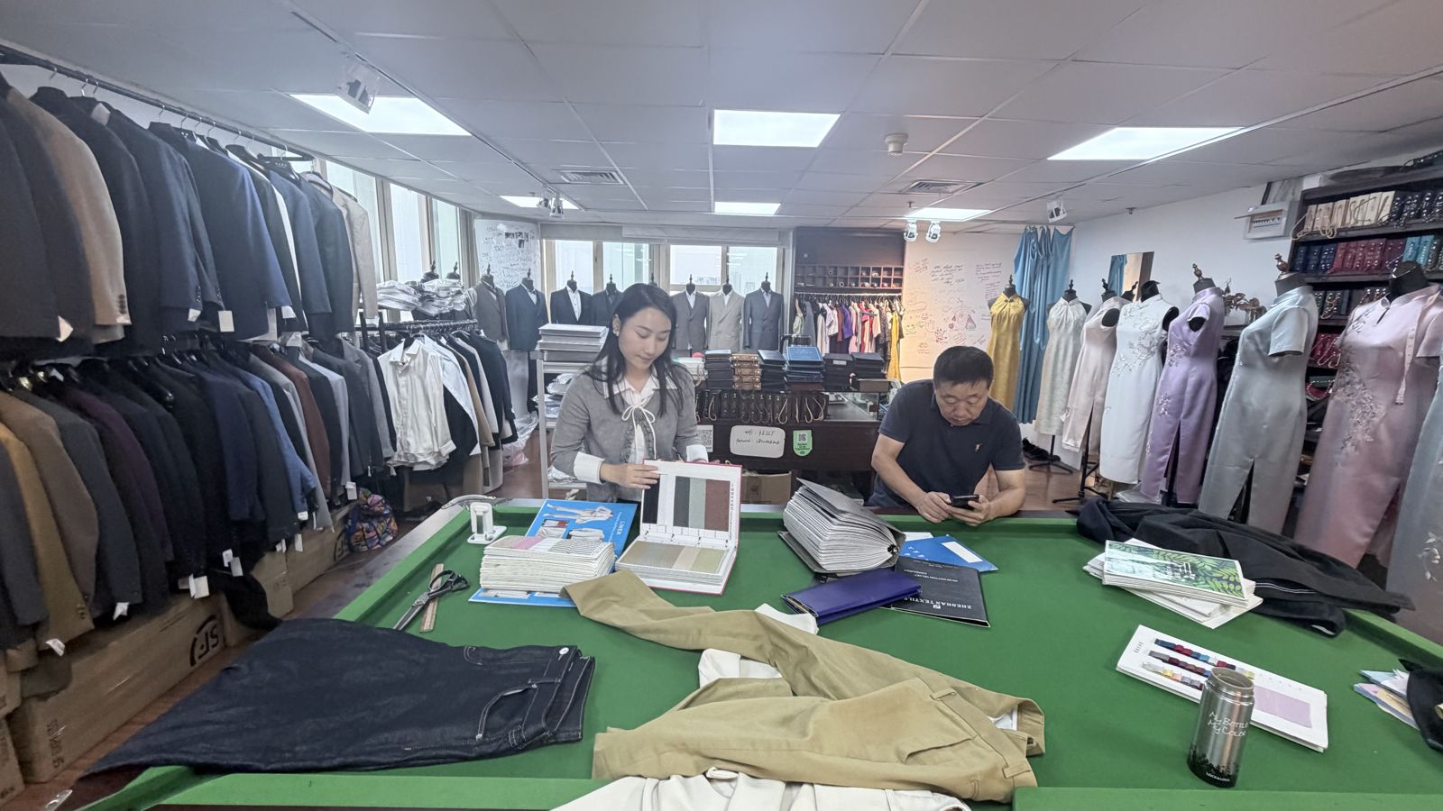 Molly Zhao's tailor's shop in Shanghai, with rails of suits and fabrics on display